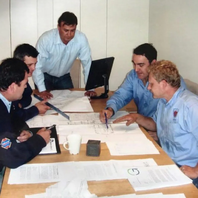 The Apartment Air Conditioning team around the planning table, reviewing installation drawings