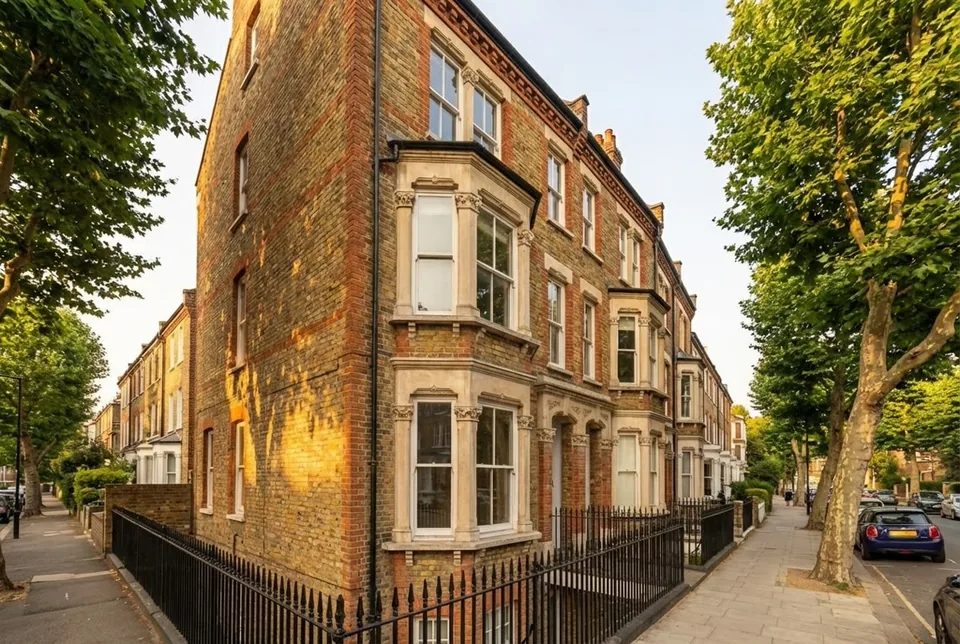 Victorian terraced conversion on a quiet London street — classic red brick, sash windows, iron railings